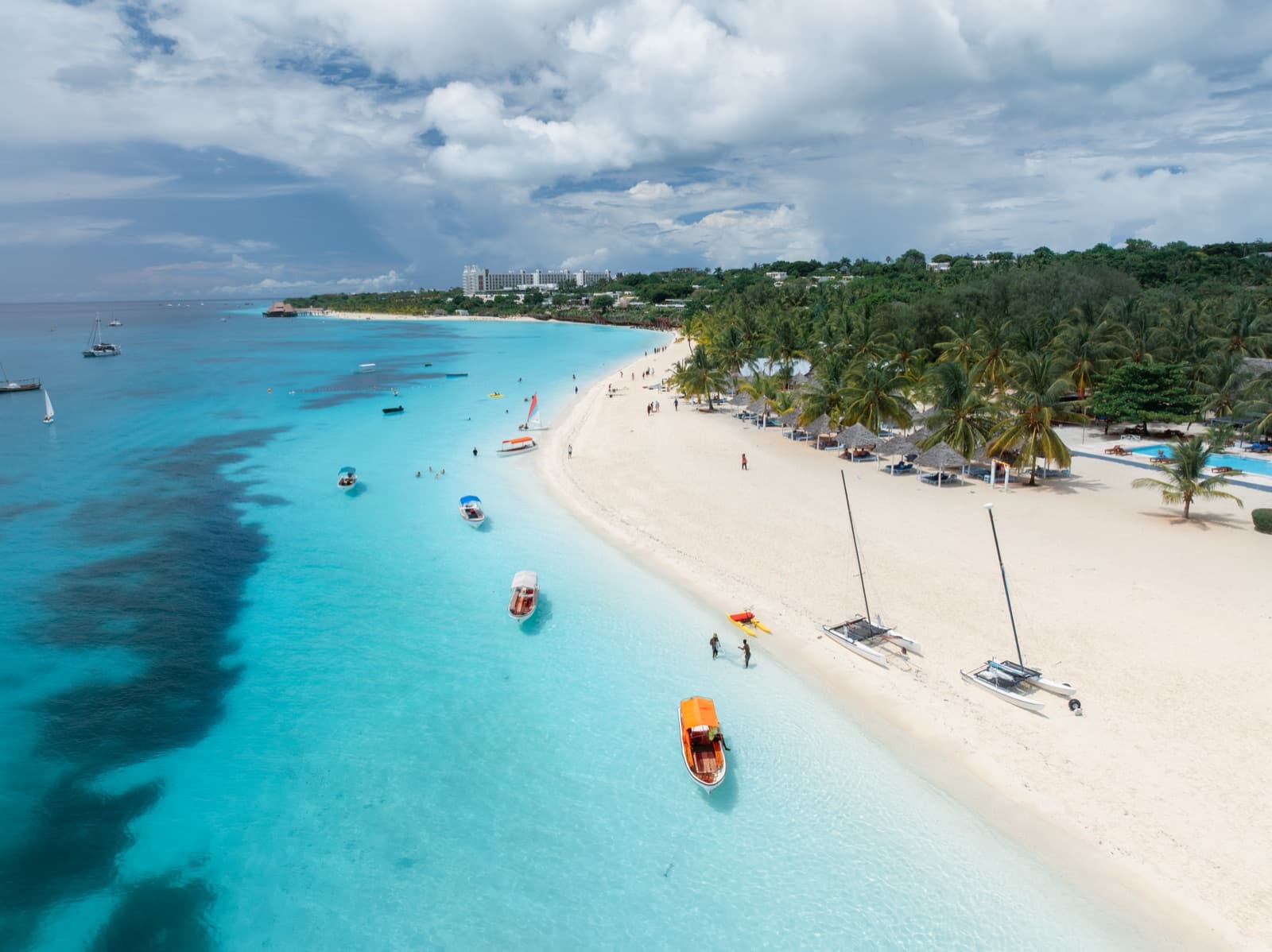 Aerial view of the white sand beach at Kendwa on Zanzibar's north coast, with catamarans and small boats drawn up on the sand